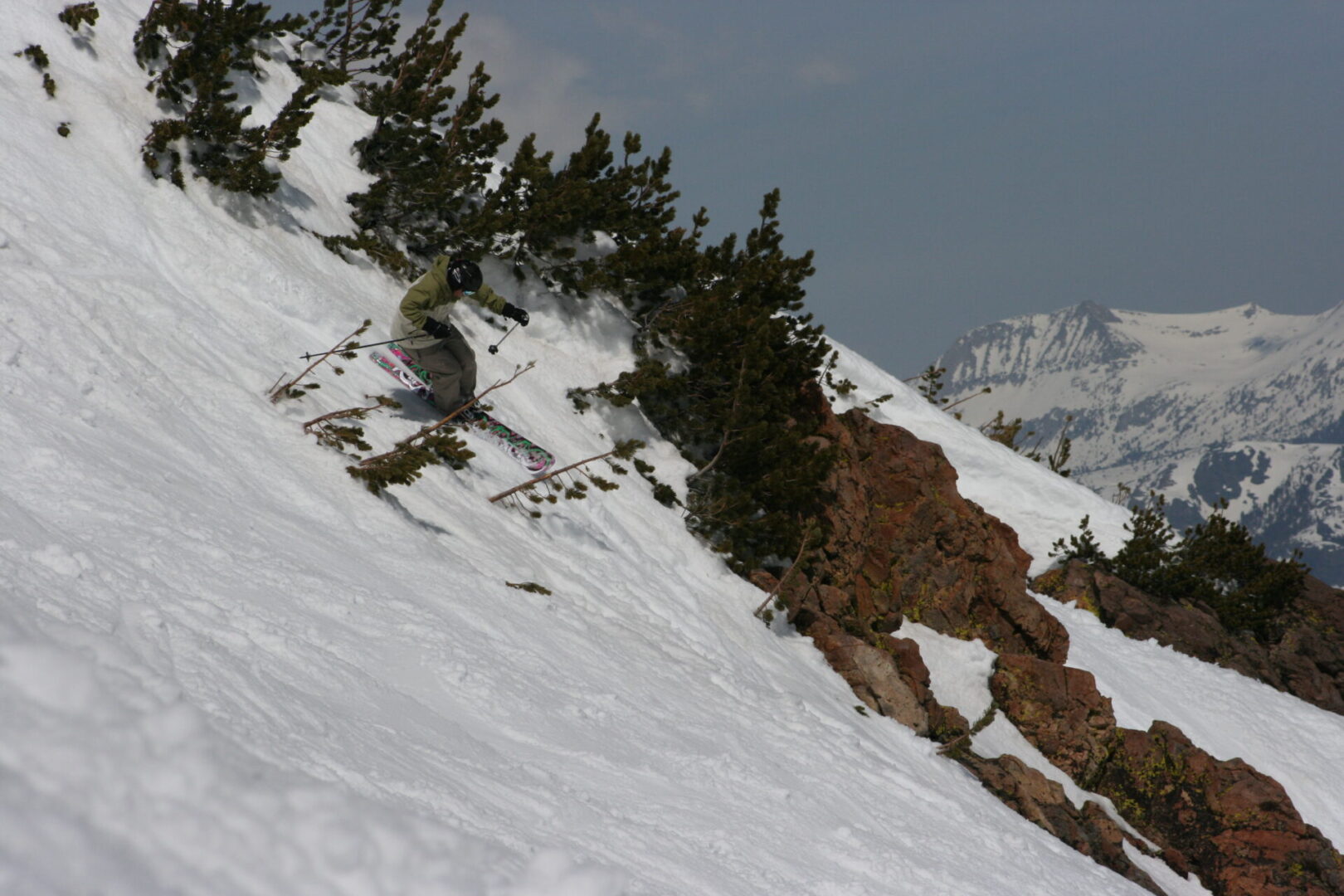 Skier carving down a snowy slope.